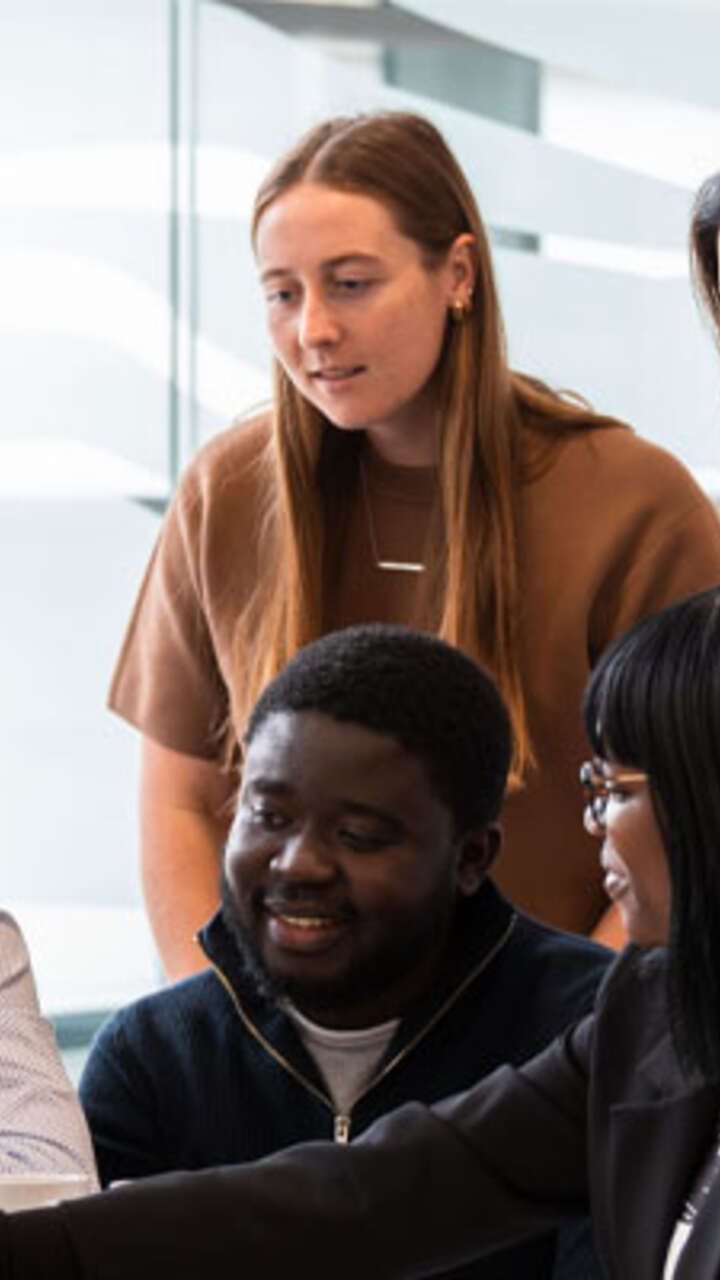 A team of your professionals looking at a presentation on a laptop