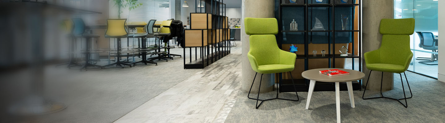 Two green chairs in a modern BDO office.
