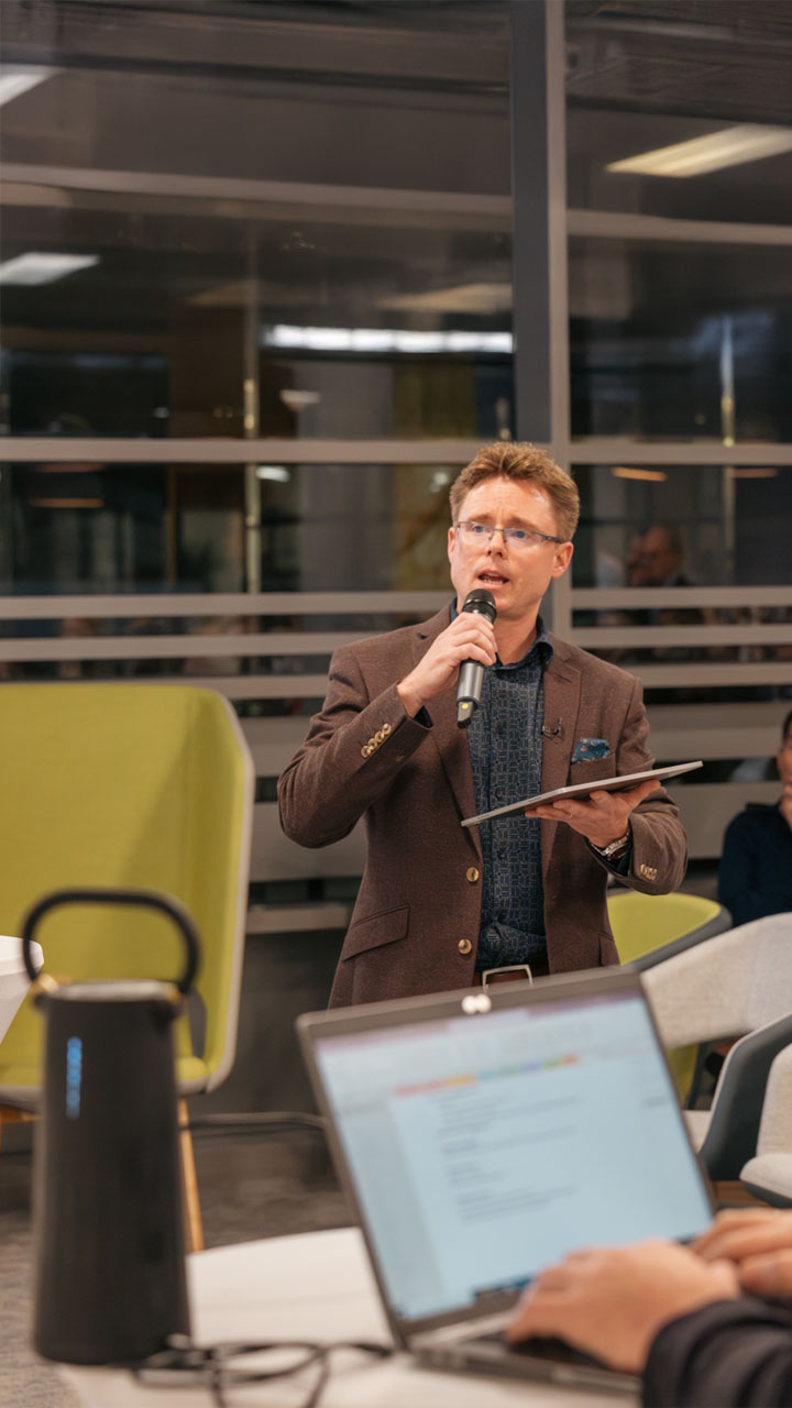 Data expert and technology specialist speaking to an audience at a conference.