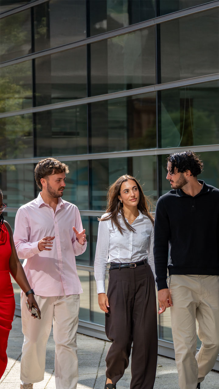 Group of smiling accountants walking together outside a new office.