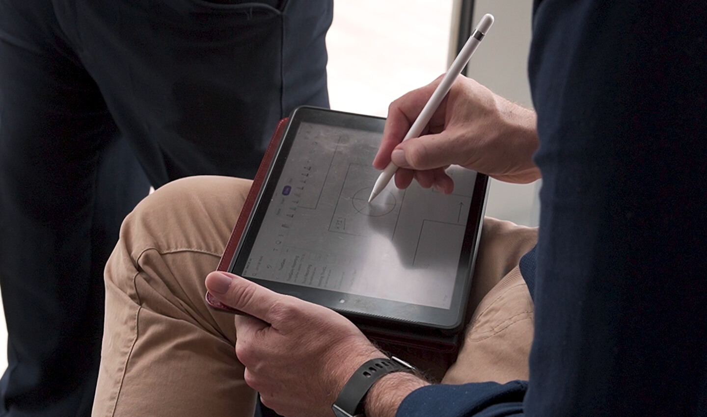 A man using a stylus on a digital tablet