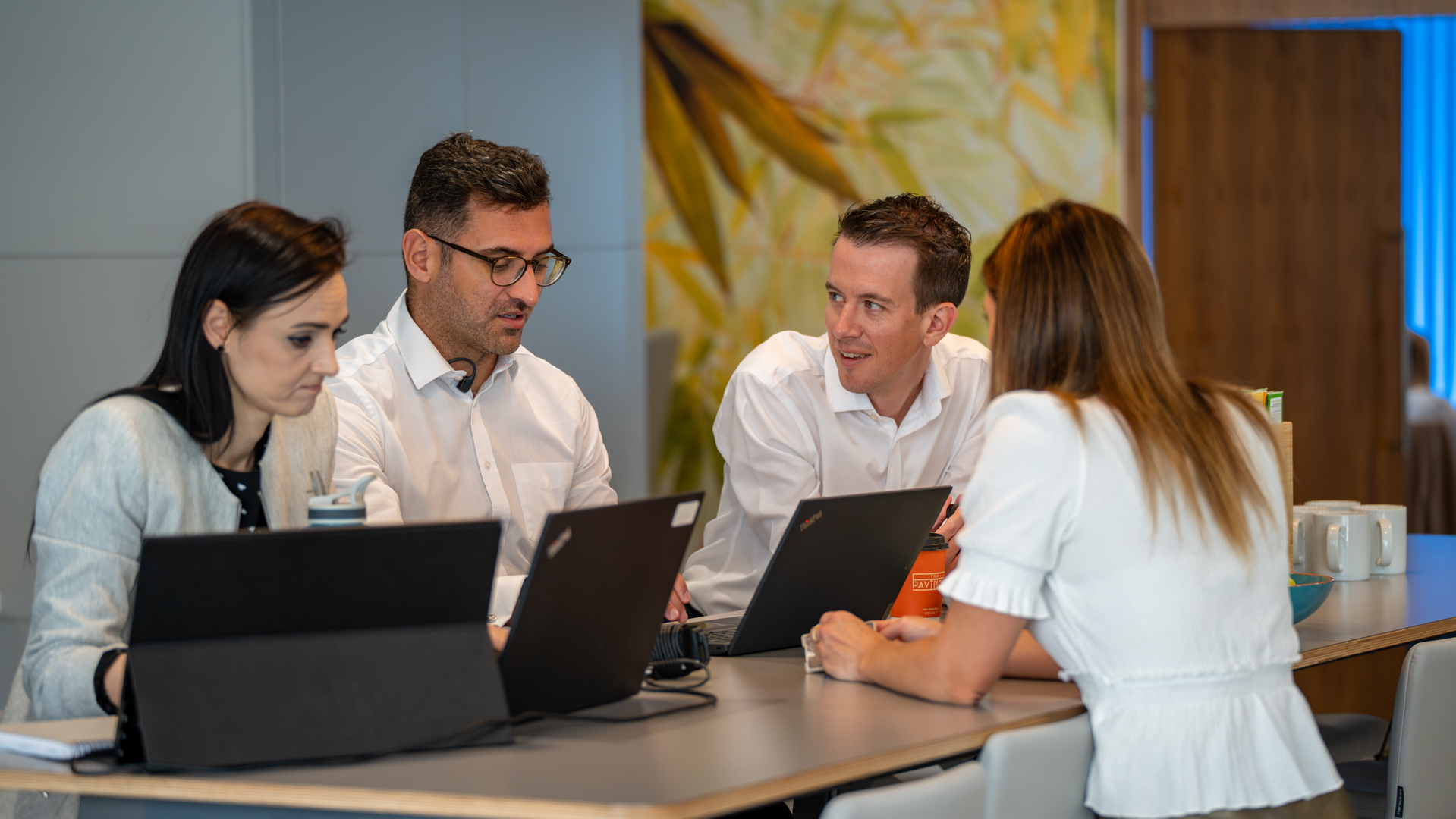 A group of Senior members of staff discussing client work