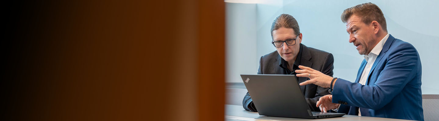 Two experienced consultants working together in a bright modern office.