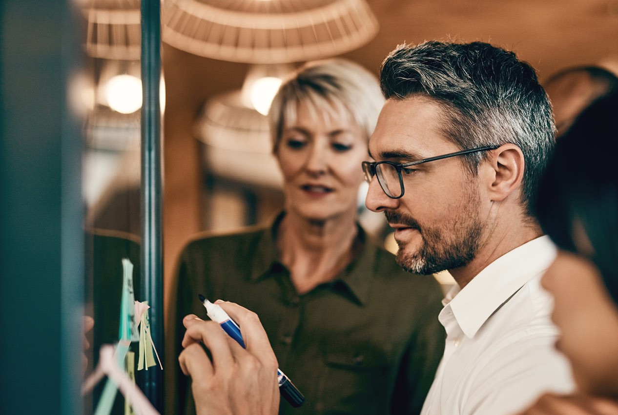 A middle Aged man leading a strategy session