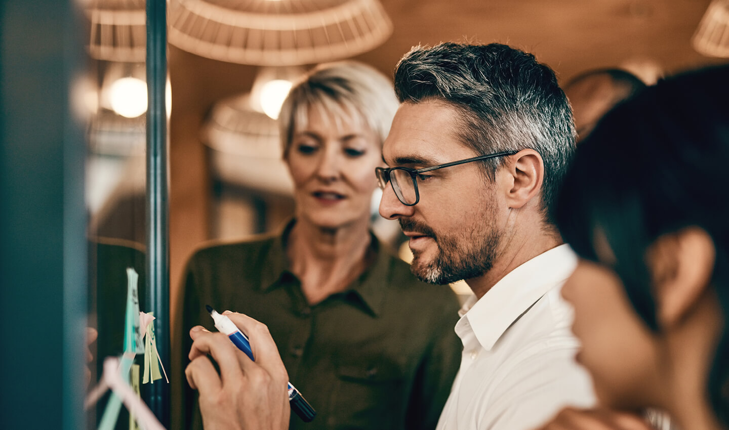 An experienced working leading a whiteboard session