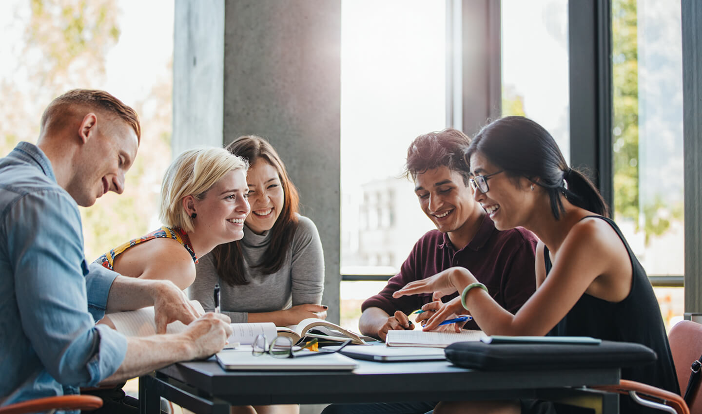 Junior associates working together around a table