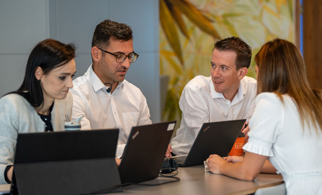A group of Audit Team members in the Board Room