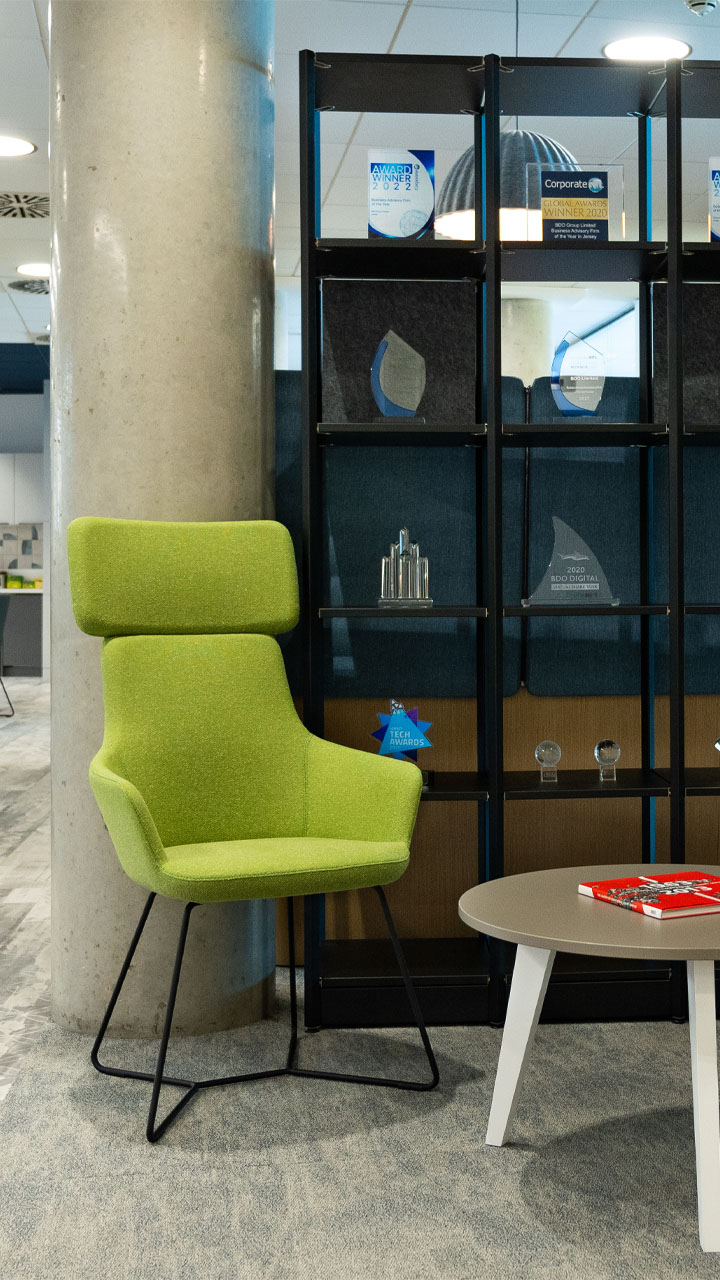 A green chair in a modern BDO office.