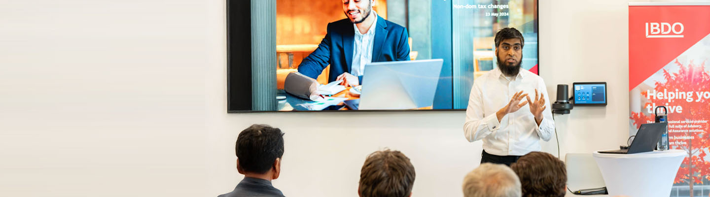 Expert tax consultant speaking to an audience at a conference.