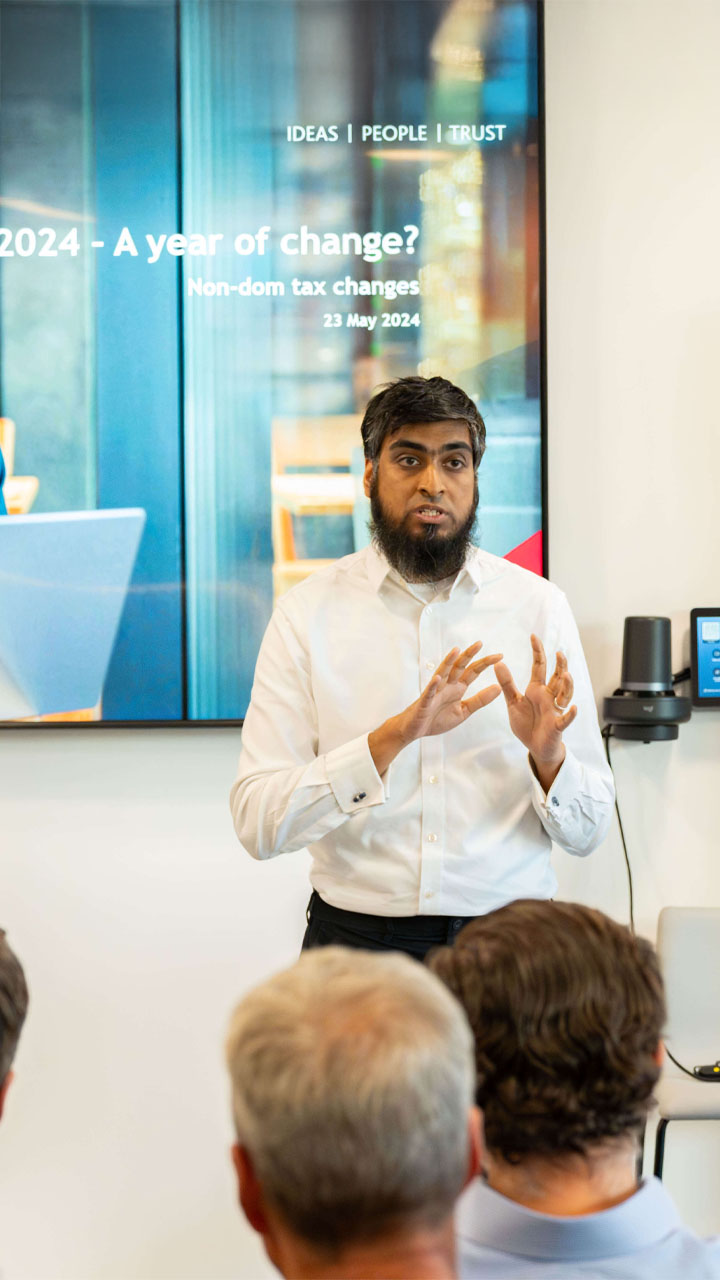 Expert tax consultant speaking to an audience at a conference.
